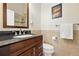 Modern bathroom featuring granite counters, dark wood vanity, and tiled floors at 9556 Kemper Dr, Lone Tree, CO 80124