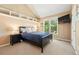 Comfortable bedroom with built-in shelves, a mounted TV, a black bed frame, and a window offers a relaxed atmosphere at 9556 Kemper Dr, Lone Tree, CO 80124
