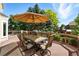 Outdoor dining on a well-maintained wooden deck with seating under a large umbrella and surrounded by trees at 9556 Kemper Dr, Lone Tree, CO 80124