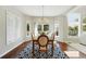 Bright dining room with modern chandelier and large windows offers a great view of the yard, as well as hardwood floors at 9556 Kemper Dr, Lone Tree, CO 80124