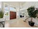 Bright foyer with tile floor, double doors, and staircase leading to the second level, as well as many windows for natural light at 9556 Kemper Dr, Lone Tree, CO 80124
