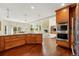 An island with a stone countertop stands in the kitchen, showcasing stainless steel appliances and connections to the dining room at 9556 Kemper Dr, Lone Tree, CO 80124