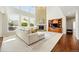 Inviting living room featuring a brick fireplace, a comfortable sofa, and built in media cabinetry with a view of the rear yard at 9556 Kemper Dr, Lone Tree, CO 80124