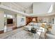 Spacious living room with hardwood floors and an open staircase, offering views of the entry doors, dining room, and kitchen at 9556 Kemper Dr, Lone Tree, CO 80124