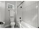 Bright bathroom featuring a sleek white tub with vertical tiles and modern matte black fixtures at 3820 Jason St # 3, Denver, CO 80211