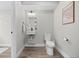 Stylish half bath with modern fixtures, floating sink, and wood-look floors, conveniently located near the entryway at 3820 Jason St # 3, Denver, CO 80211