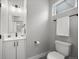 Cozy bathroom with a single vanity, modern lighting and a commode with a towel rack at 3820 Jason St # 3, Denver, CO 80211