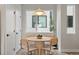 Cozy dining area with modern lighting, a round wooden table, and comfortable seating next to a bright window at 3820 Jason St # 3, Denver, CO 80211