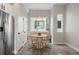 Charming dining area with stylish lighting, a round wooden table, and stainless steel refrigerator, ideal for meals at 3820 Jason St # 3, Denver, CO 80211