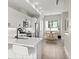 A well-appointed modern kitchen flows into the dining area featuring stainless steel appliances and quartz countertops at 3820 Jason St # 3, Denver, CO 80211