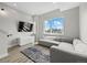 Bright living room with sectional couch, city views, a television, and designer rug at 3820 Jason St # 3, Denver, CO 80211