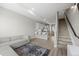 Open-concept living space flows into the kitchen, featuring modern design and staircase at 3820 Jason St # 3, Denver, CO 80211