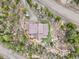 A mountain home with wood siding and brown roof is nestled among the trees with a patch of green grass yard at 11766 Coal Creek Heights Dr, Golden, CO 80403