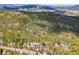 Mountain homes dot the landscape nestled among the trees with views of the mountains in the background at 11766 Coal Creek Heights Dr, Golden, CO 80403