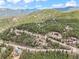 Mountain homes dot the landscape nestled among the trees with views of mountains in the background at 11766 Coal Creek Heights Dr, Golden, CO 80403
