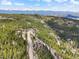 Mountain homes dot the landscape nestled among the trees with views of snow capped mountains in the background at 11766 Coal Creek Heights Dr, Golden, CO 80403