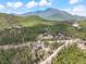 Mountain homes dot the landscape nestled among the trees with views of mountains and a lake in the background at 11766 Coal Creek Heights Dr, Golden, CO 80403