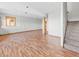 Open basement area featuring hardwood flooring, natural wood support columns, and a staircase to upper level at 11766 Coal Creek Heights Dr, Golden, CO 80403