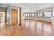 Large basement area with hardwood flooring, natural wood accents, and multiple windows providing natural light at 11766 Coal Creek Heights Dr, Golden, CO 80403