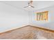 Bright bedroom featuring hardwood floors, a wood-trimmed window, and a ceiling fan at 11766 Coal Creek Heights Dr, Golden, CO 80403
