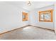 Cozy bedroom with carpet flooring, white walls, and wood-trimmed windows, creating a serene atmosphere at 11766 Coal Creek Heights Dr, Golden, CO 80403