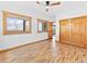 Spacious bedroom featuring hardwood floors, wood-trimmed windows, and closet at 11766 Coal Creek Heights Dr, Golden, CO 80403