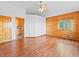 Wood paneled bedroom with hardwood floors, a ceiling fan, and windows with natural light at 11766 Coal Creek Heights Dr, Golden, CO 80403
