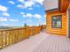 A beautiful deck with wood railing overlooks a scenic mountain view at 11766 Coal Creek Heights Dr, Golden, CO 80403