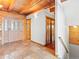 Inviting entryway with tile floors, wood ceiling beams, and wooden doors at 11766 Coal Creek Heights Dr, Golden, CO 80403
