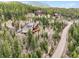 A beautiful mountain home with wood siding and a large deck is nestled among the trees on a hillside at 11766 Coal Creek Heights Dr, Golden, CO 80403