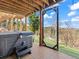 Outdoor deck featuring a hot tub and scenic views of the wooded surroundings at 11766 Coal Creek Heights Dr, Golden, CO 80403
