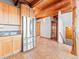 Kitchen featuring stainless steel appliances, wood cabinetry, and tile flooring, with a view of stairs at 11766 Coal Creek Heights Dr, Golden, CO 80403