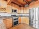 Well-equipped kitchen with granite countertops, stainless steel appliances, and wood cabinets at 11766 Coal Creek Heights Dr, Golden, CO 80403