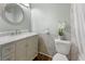 Bright bathroom features a decorative mirror and modern vanity with marble countertops at 18625 E Kent Dr, Aurora, CO 80013