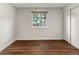 Bedroom with hardwood floors, a window with tree views, and sliding door closet at 18625 E Kent Dr, Aurora, CO 80013