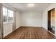 Spacious bedroom with hardwood floors and a large window that offers ample natural light at 18625 E Kent Dr, Aurora, CO 80013