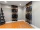 Bedroom with rustic floors, patterned curtains, and a dark shelf for storage at 18625 E Kent Dr, Aurora, CO 80013