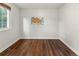 Bedroom features wood floors, natural light from the window, and a map on the wall at 18625 E Kent Dr, Aurora, CO 80013