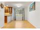 Sunlit dining area features wood floors, modern chandelier, and views of the backyard at 18625 E Kent Dr, Aurora, CO 80013