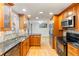 Stylish kitchen with granite countertops, stainless steel appliances, and hardwood floors at 18625 E Kent Dr, Aurora, CO 80013
