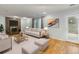 Cozy living room featuring a brick fireplace, neutral decor, and ample seating at 18625 E Kent Dr, Aurora, CO 80013