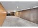 Unfinished basement area featuring ample space and brick accent wall at 6512 Upham St, Arvada, CO 80003