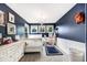 Charming bedroom with navy walls, wainscoting, and playful decor accents at 5265 S Cathay Way, Centennial, CO 80015