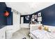 Cozy bedroom featuring a crib, white wainscoting, and playful wall decor at 5265 S Cathay Way, Centennial, CO 80015