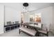 Dining area features a modern light fixture, a long wooden table, and a decorative bench at 5265 S Cathay Way, Centennial, CO 80015