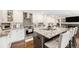 Modern kitchen featuring a granite island, stainless steel appliances, and white cabinetry at 5265 S Cathay Way, Centennial, CO 80015