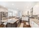 A spacious kitchen featuring an island with granite countertops, white cabinets, and stainless steel appliances at 5265 S Cathay Way, Centennial, CO 80015