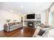 Cozy living room with a fireplace, built-in shelving, and hardwood floors at 5265 S Cathay Way, Centennial, CO 80015