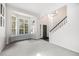 Bright living room featuring a bay window, neutral walls, staircase, and modern lighting fixture at 5265 S Cathay Way, Centennial, CO 80015