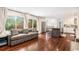 Sun-drenched living room seamlessly connects to the kitchen, featuring hardwood floors and outdoor access at 5265 S Cathay Way, Centennial, CO 80015